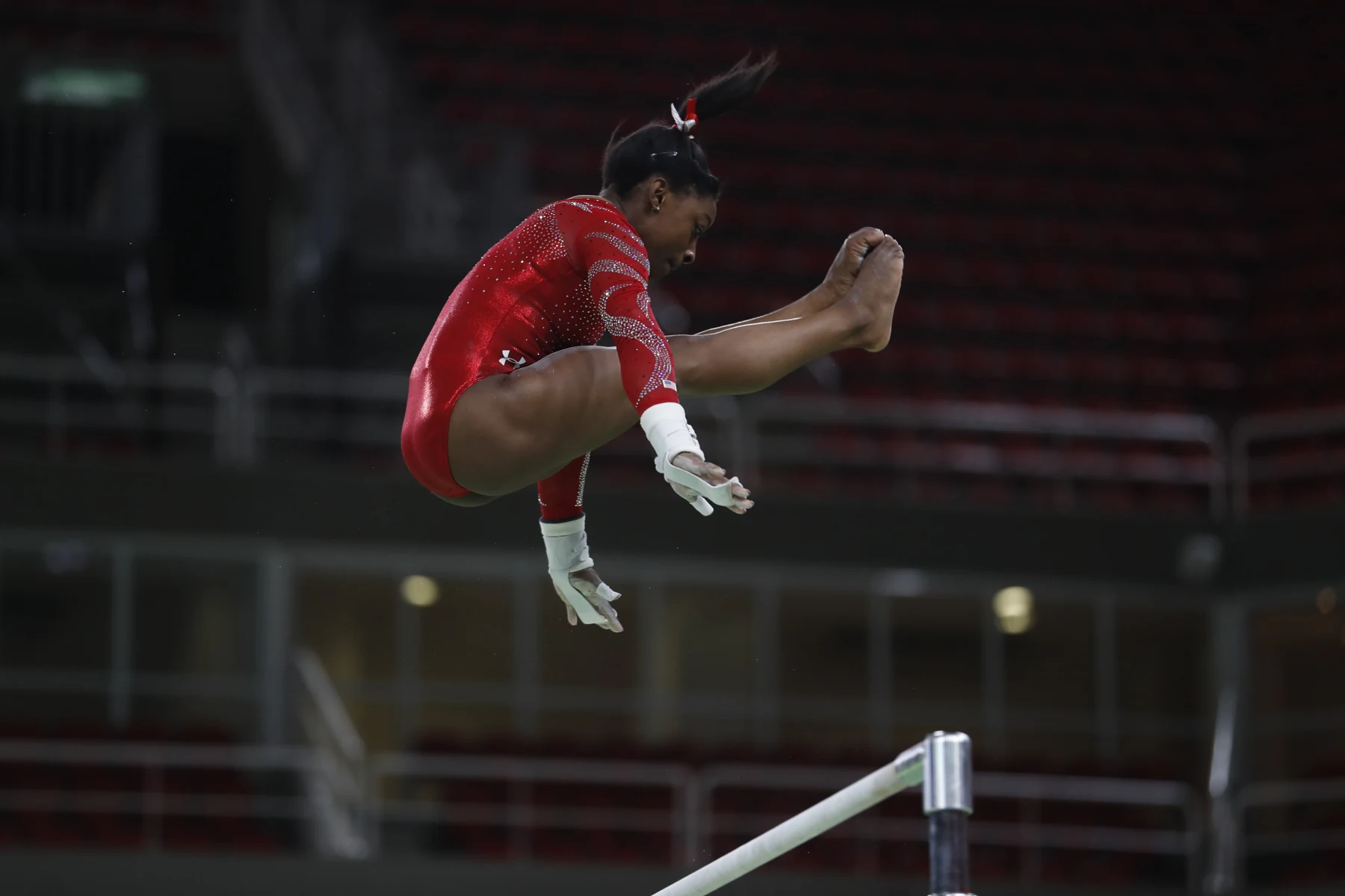 Simone Biles esegue un esercizio alle parallele asimmetriche durante un allenamento per i Giochi di Rio 2016